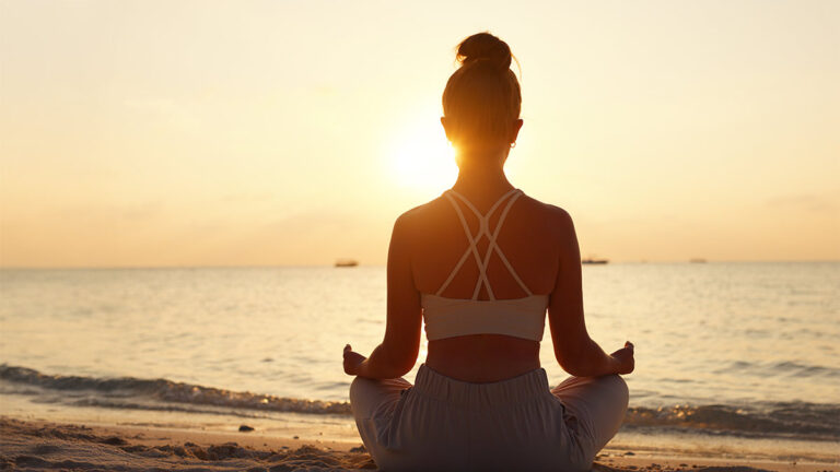 guide to mindfulness meditation, woman meditating on beach